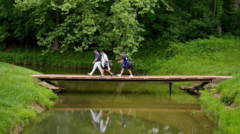 Shane Lowry, of Ireland, walks across the bridge on the...