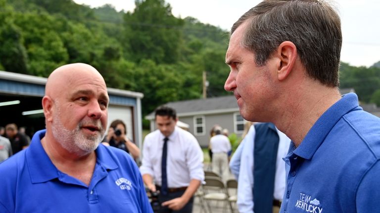 Kentucky Gov. Andy Beshear, right, speaks with community members at...