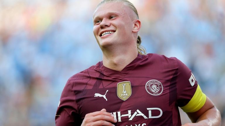 Manchester City's Erling Haaland smiles as he celebrates his second...