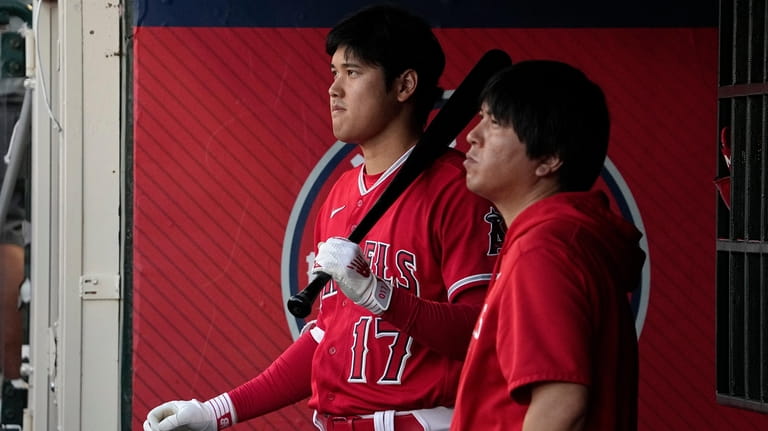 Los Angeles Angels' Shohei Ohtani stands with his interpreter Ippei...
