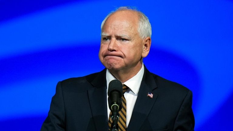 Democratic vice presidential nominee Minnesota Gov. Tim Walz reacts as...