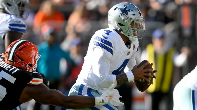 Dallas Cowboys quarterback Dak Prescott (4) scrambles away from pressure...