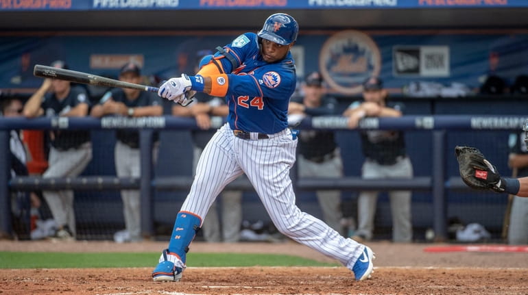 New York Mets' Robinson Cano swings during a spring training...