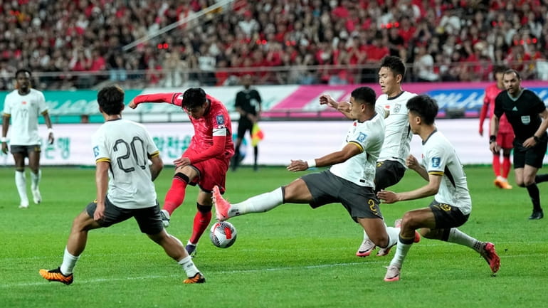 South Korea's Son Heung-min, center left, makes an attempt to...