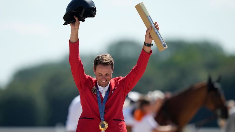 Germany's Christian Kukuk celebrates with his gold medal after winning...