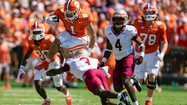 Clemson running back Will Shipley (1) jumps over Florida State...