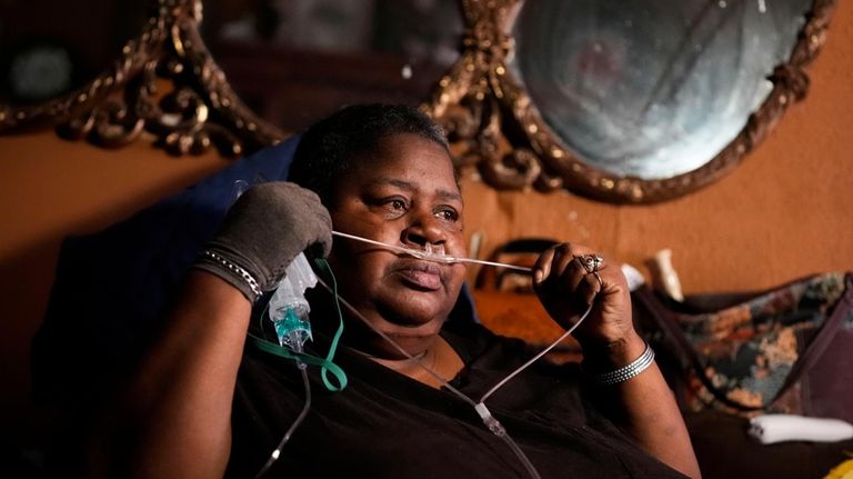 Shelia Mae Dobbins holds part of her oxygen tube inside...