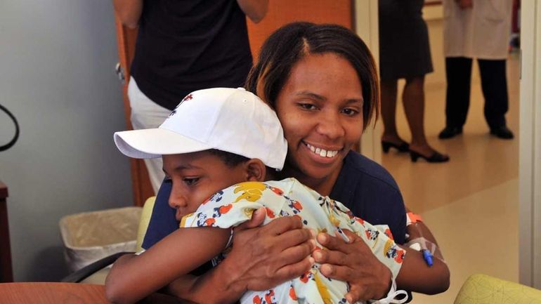 Terrian Walker hugs her 11-year-old son, Christopher Walker, at Cohen...