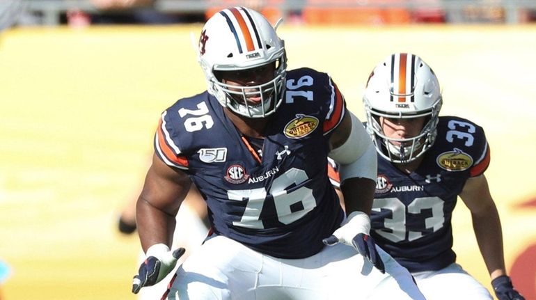 Auburn Tigers offensive lineman Prince Tega Wanogho blocks a defender in...