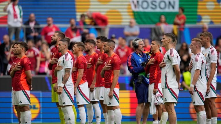 Hungary's players react at the end of a Group A...