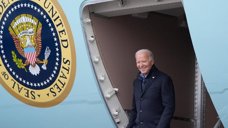 President Joe Biden walks off Air Force One upon arrival,...