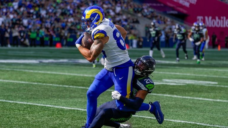 Los Angeles Rams tight end Tyler Higbee is tackled by...