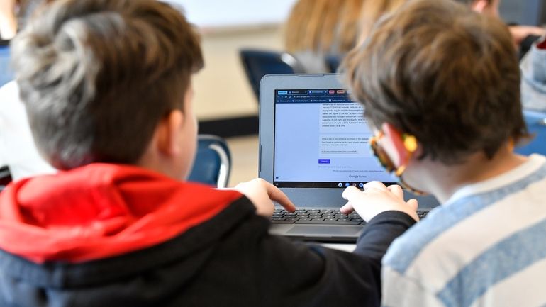 Students work on a laptop computer at Stonewall Elementary in...