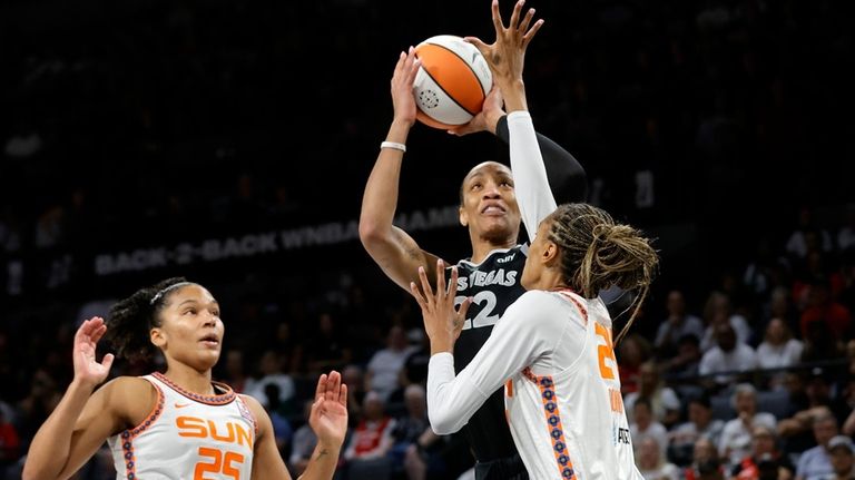 Las Vegas Aces center A'ja Wilson (22) shoots between Connecticut...