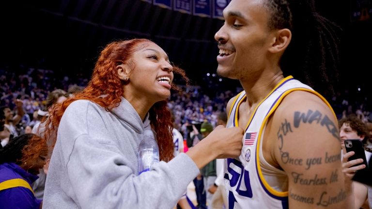 LSU students, including LSU women's basketball forward Angel Reese, left,...