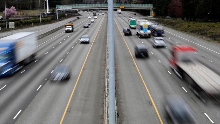 Cars and trucks travel on Interstate 5 near Olympia, Wash.,...