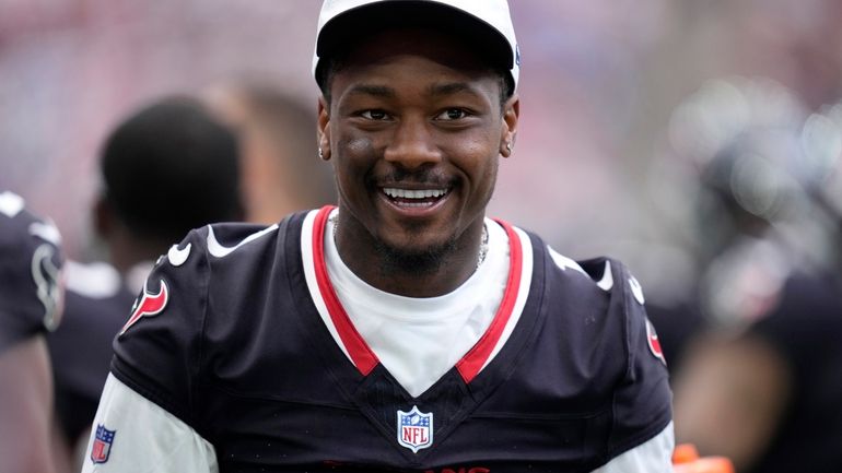 Houston Texans wide receiver Stefon Diggs walks along the sideline...