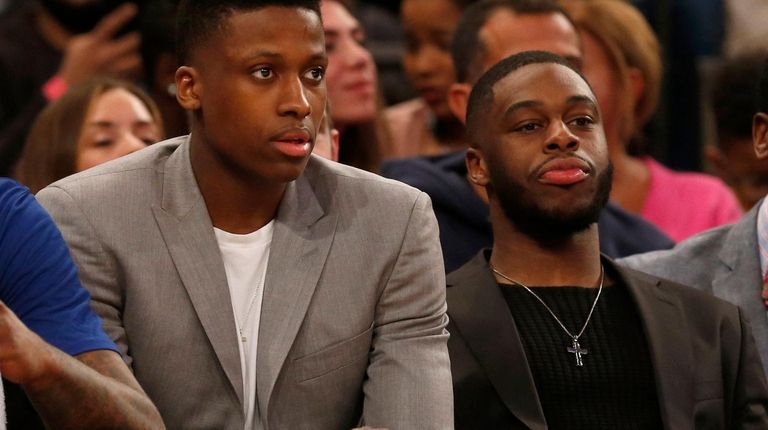 Frank Ntilikina #11 and Emmanuel Mudiay #1 of the New...