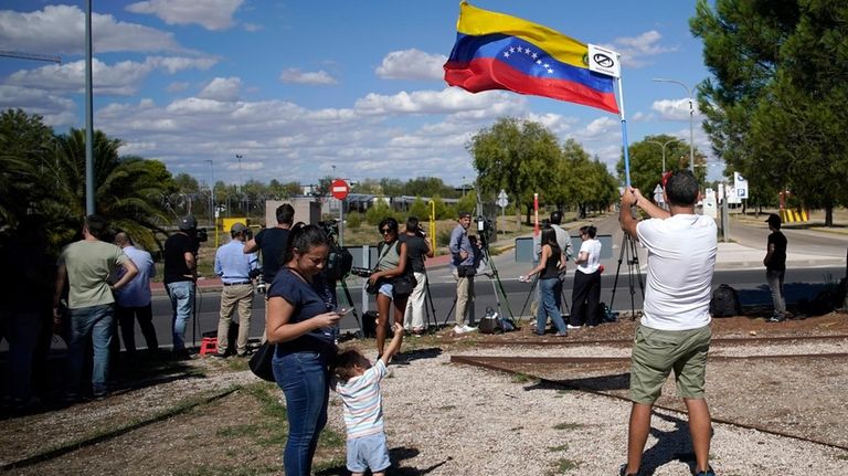 Supporters of Edmundo González wait for his arrival outside the...