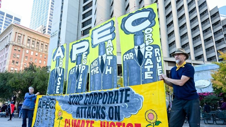 Demonstrators prepare to march in opposition to the APEC Summit...