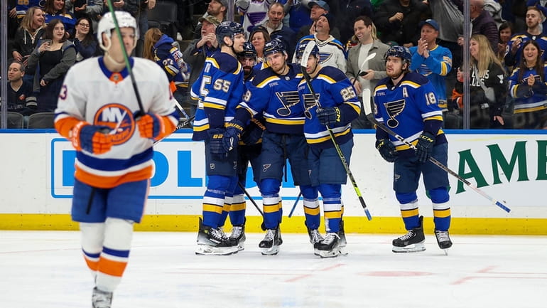 The Blues' Pavel Buchnevich is congratulated by teammates after scoring during...