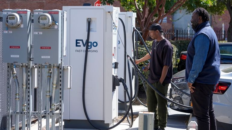 ChargerHelp! Field Service Manager Clyde Ellis, right, talks to James...