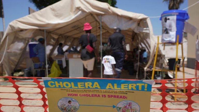 A family is seen entering a tent set aside for...