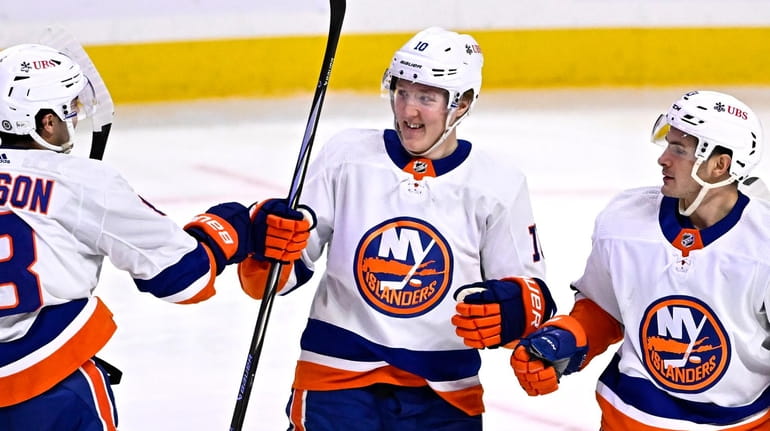 Islanders right wing Simon Holmstrom (10) celebrates after his goal...