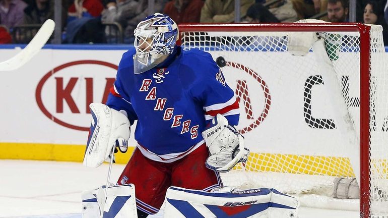 Henrik Lundqvist surrenders a second-period goal against James Wisniewski #21...