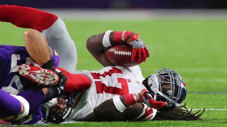 Dwayne Harris of the New York Giants is tackled by...