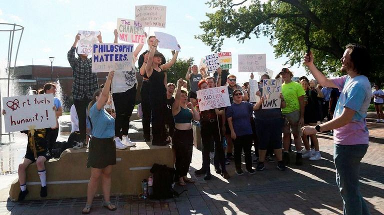 Students and other supporters protest budget cuts at the University...