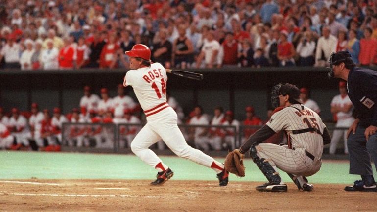 Cincinnati Reds Pete Rose hits a line drive to break...