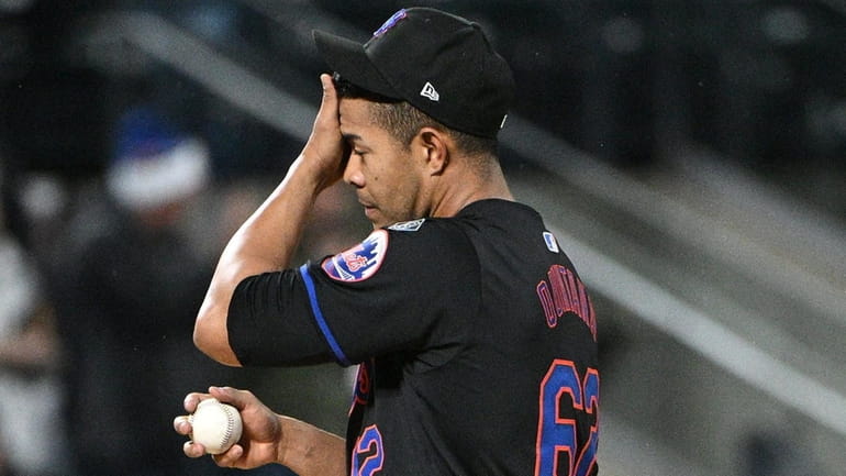 Jose Quintana reacts on the mound after giving up a...