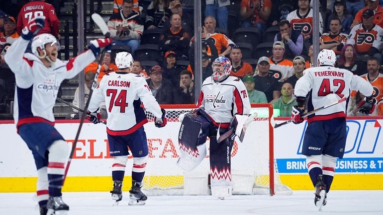 Washington Capitals' Charlie Lindgren (79) celebrates with Martin Fehervary (42)...