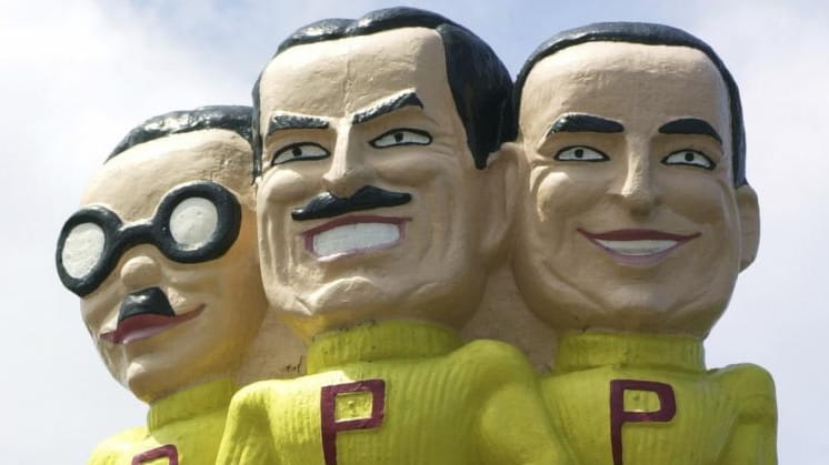 Pep Boys mascots Manny, Moe, and Jack above a store...
