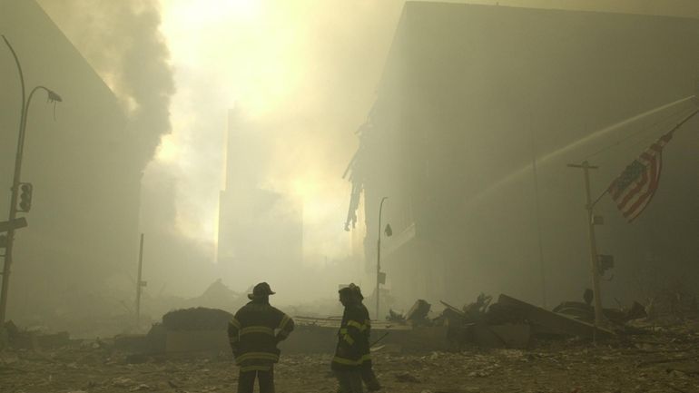 Emergency workers at Ground Zero on Sept. 11, 2001. An estimated 400,000...