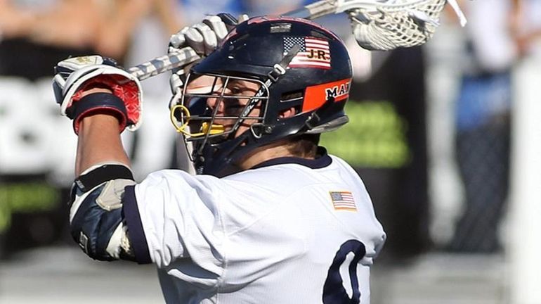 Manhasset's Pat Moroney (8) with the shot and score in...