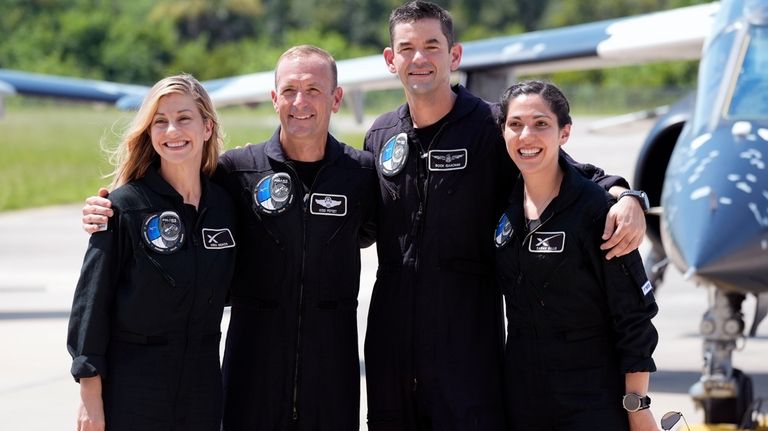 Astronauts, from left, mission specialist Anna Menon, pilot Scott Poteet,...