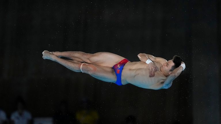 China's Cao Yuan competes in the men's 10m platform diving...