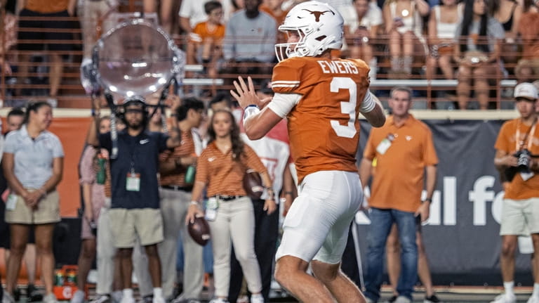 Texas quarterback Quinn Ewers looks to pass during the first...