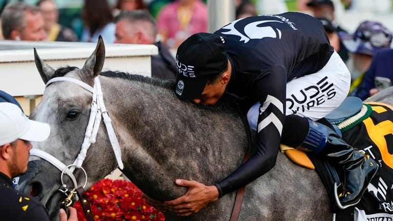 Jaime Torres kisses Seize The Grey after they won the...