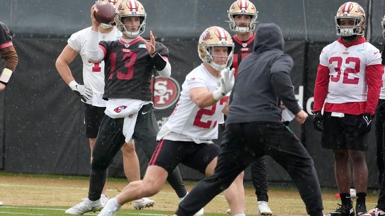 San Francisco 49ers quarterback Brock Purdy (13) and running back...