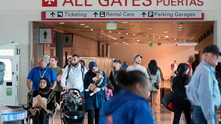 Travelers make thier way through Love Field Airport in Dallas...