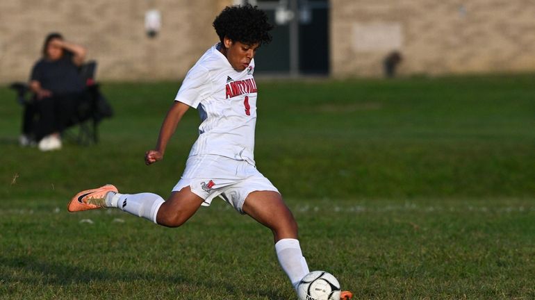 Hector Mejia of Amityville sends a foul kick into the...