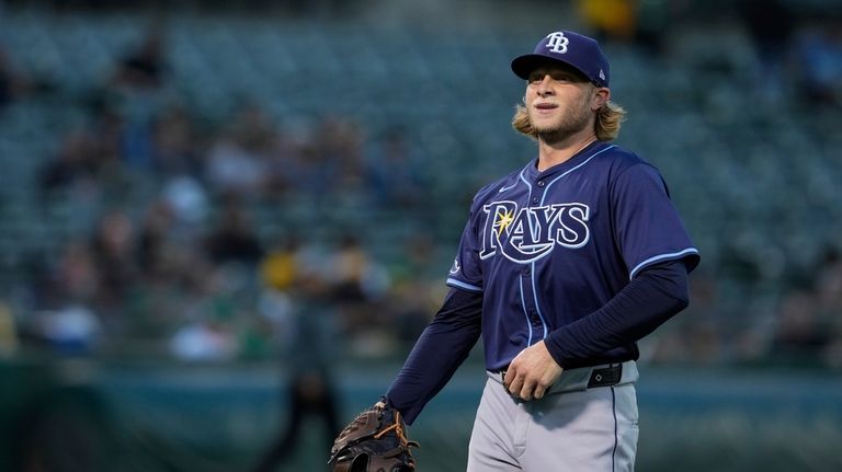 Tampa Bay Rays' Shane Baz walks to the dugout after...