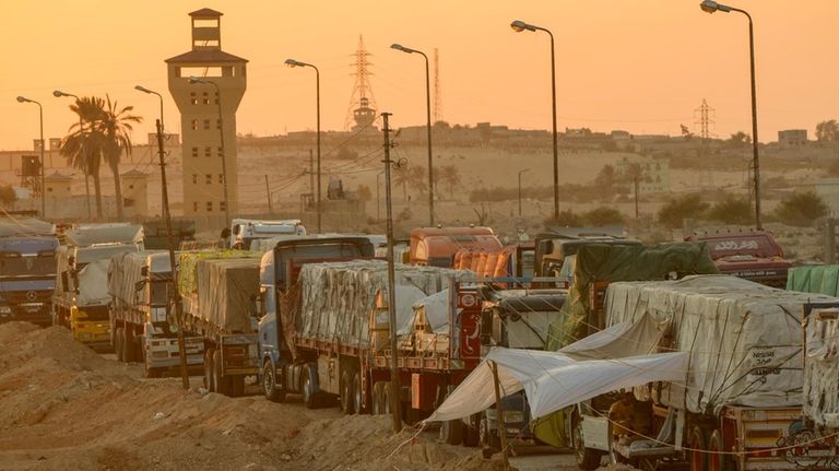 Trucks of humanitarian aids wait to cross the Rafah border...