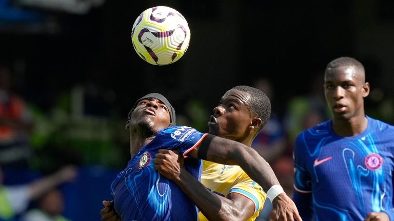 Chelsea's Noni Madueke, left, and Crystal Palace's Tyrick Mitchell, center,...