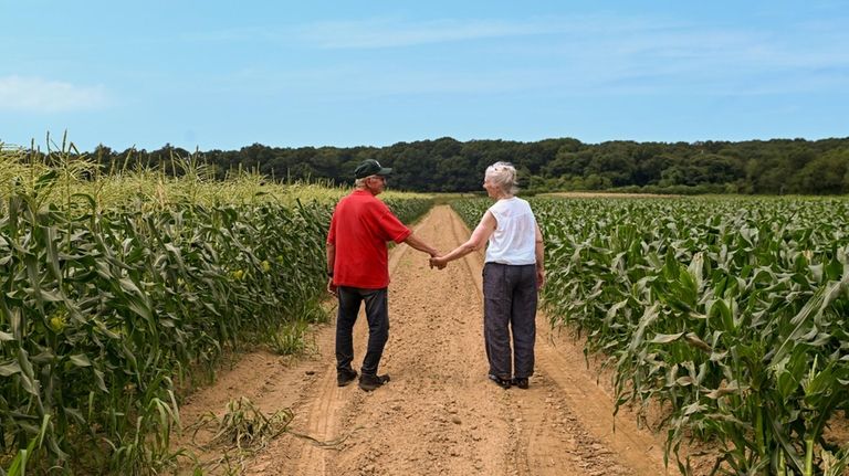 John and Rita Sepenoski walk down the road at their...