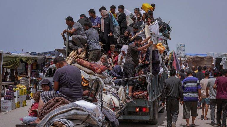 Palestinians fleeing from the southern Gaza city of Rafah during...