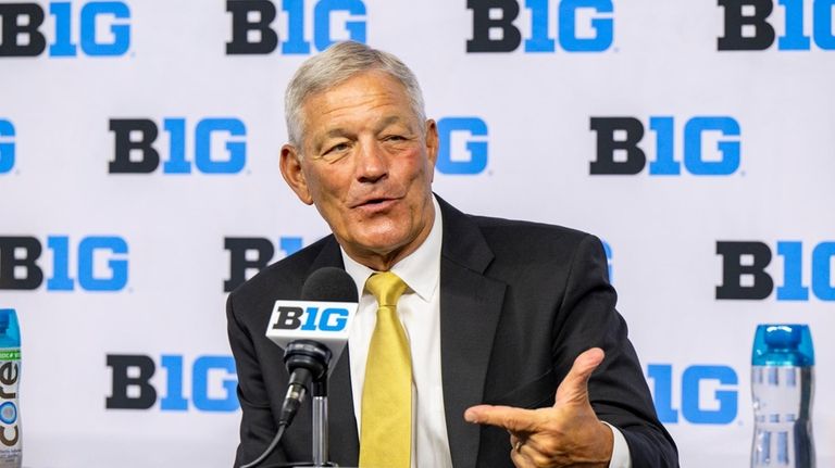 Iowa head coach Kirk Ferentz talks with reporters during an...